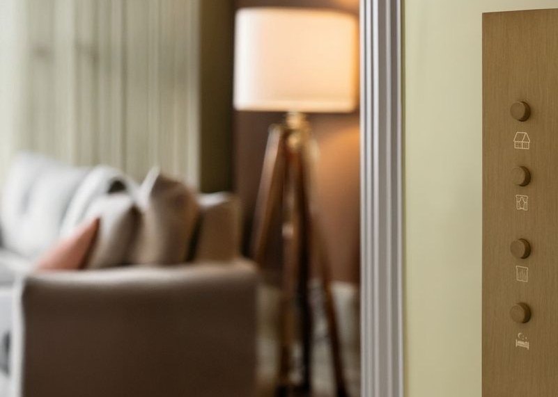 Focus SB bronze push-button keypad beside an armchair