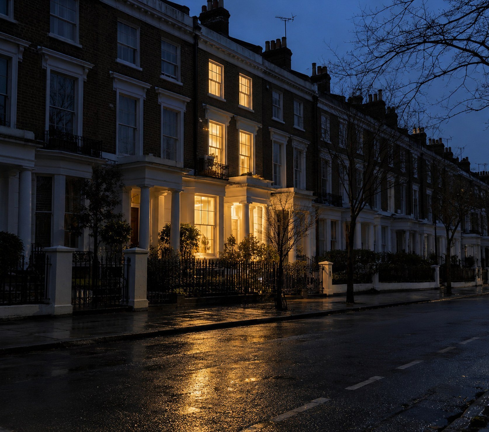 London street in a power cut, one townhouse still lit inside