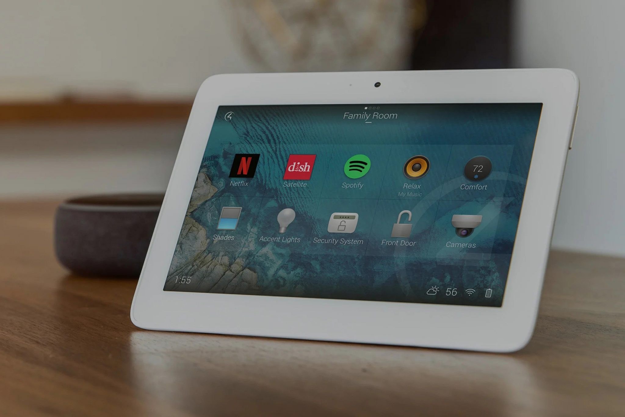 Tabletop touchscreen showing app icons on a wooden table