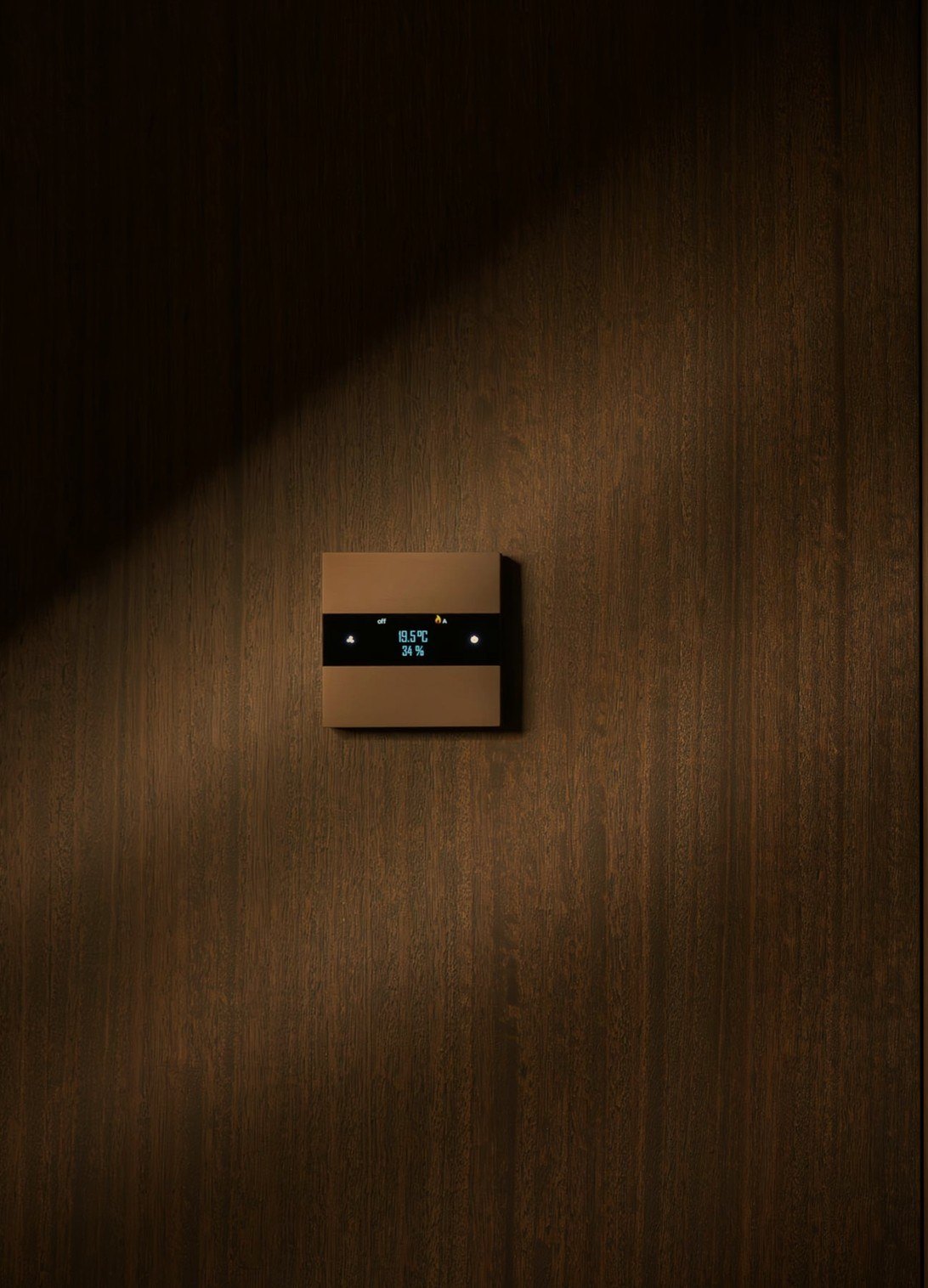 Basalte Deseo thermostat in bronze on dark oak panelling