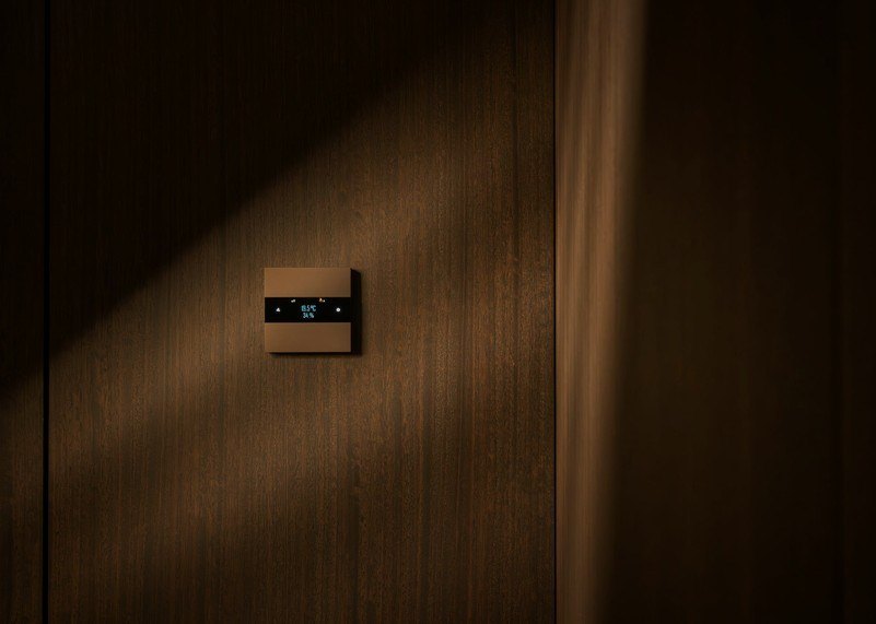 Basalte Deseo thermostat in bronze on dark oak panelling