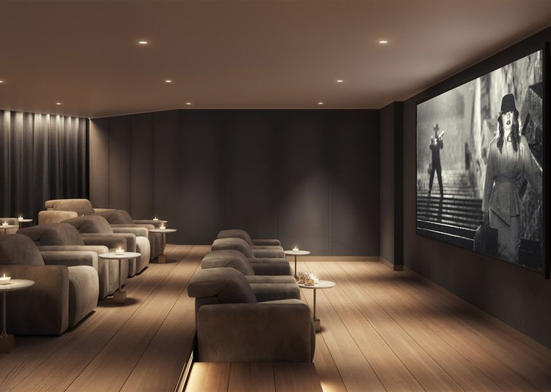Private cinema with rows of lounge chairs facing a screen