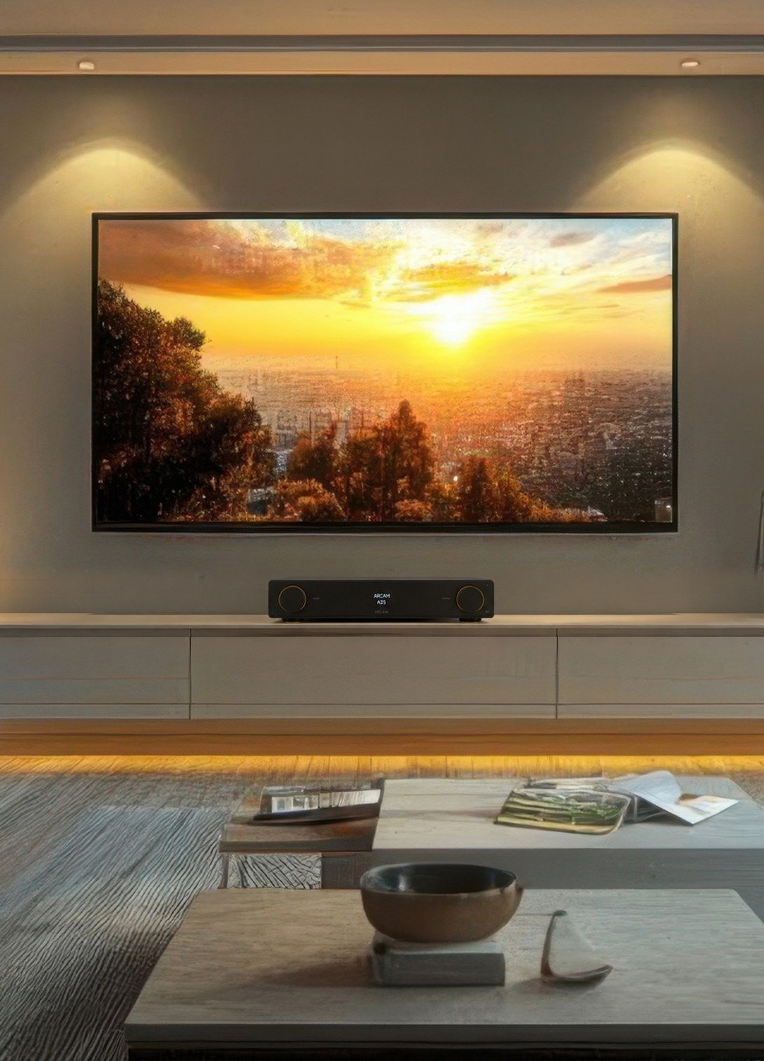 Living room with a wall-mounted TV and an Arcam Radia amplifier on the media console