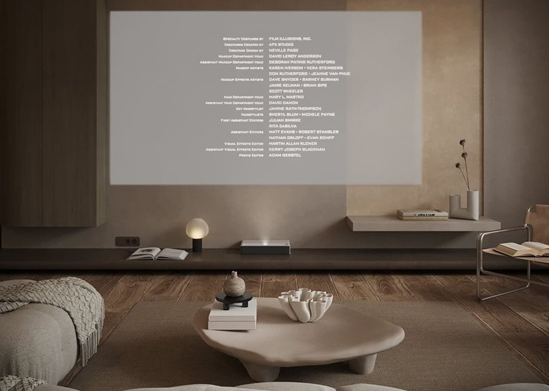 Media room with film credits projected on the wall above a low sofa